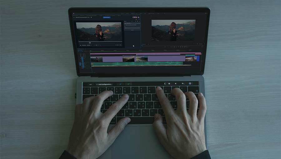 Compliance specialist reviewing marketing assets on his laptop