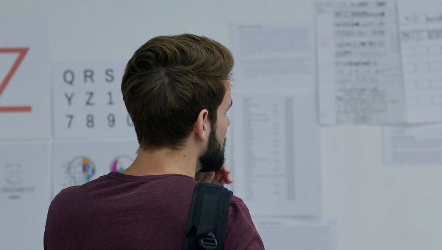 Business marketing team member comparing proofs in a whiteboard