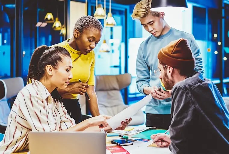 Collaborative team brainstorming brand assets to form a company branding strategy