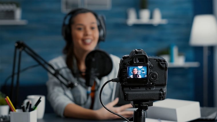 Content Creator talking to a DSLR camera