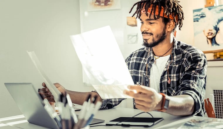 Creative designer studying creative feedback of his work by coworkers