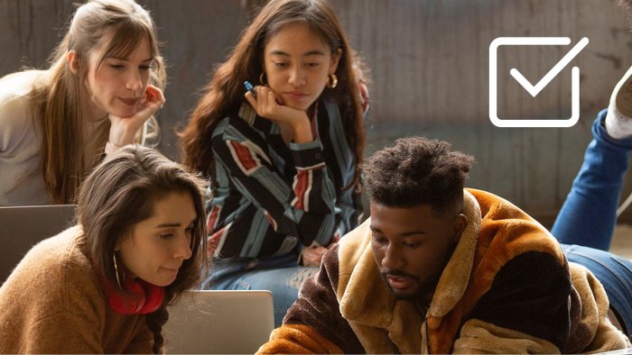 Creative team working by a laptop on a project.