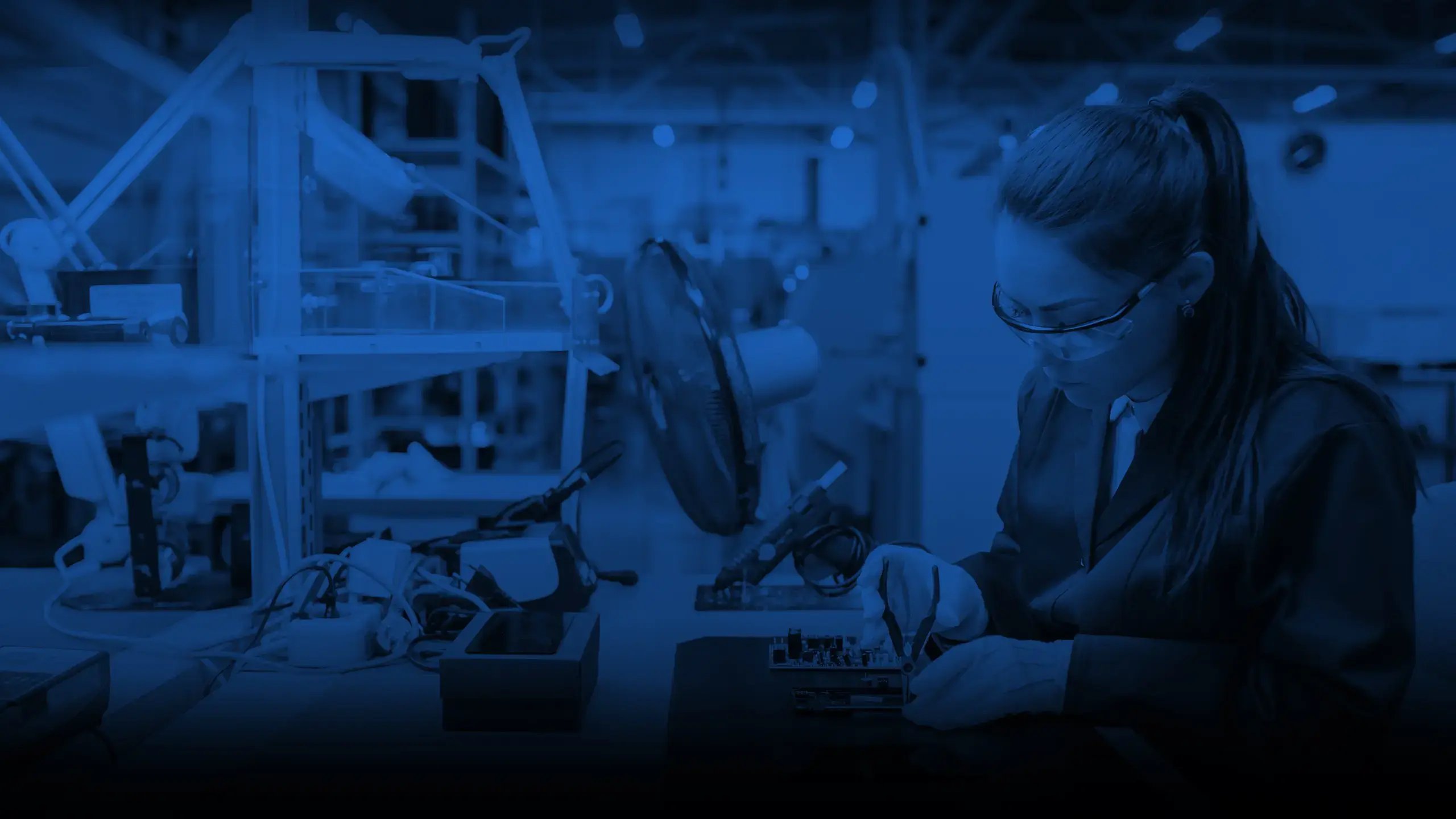 Hero background - woman assembling electronic units circuits in a production environment