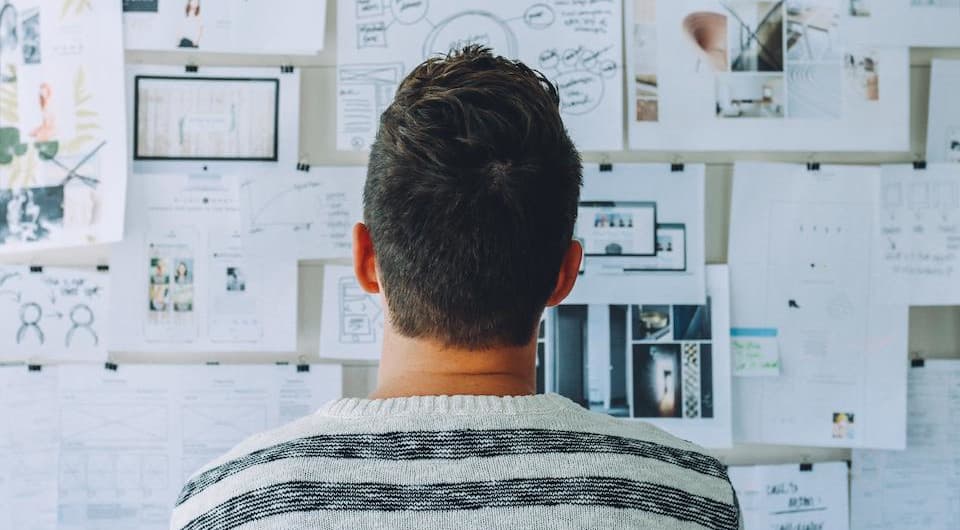 How to write a rock solid design brief (with examples) - man standing in front of dashboard