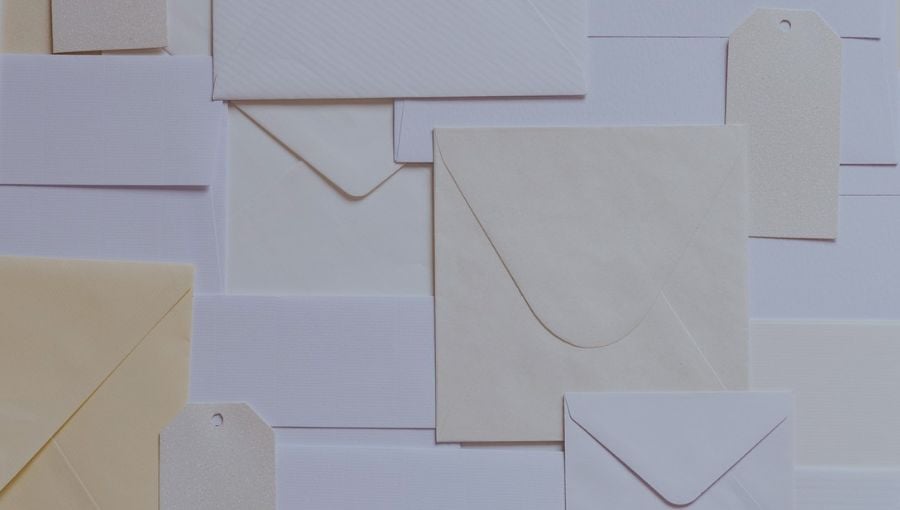 Mail paper letters envelopes stacked in a mess