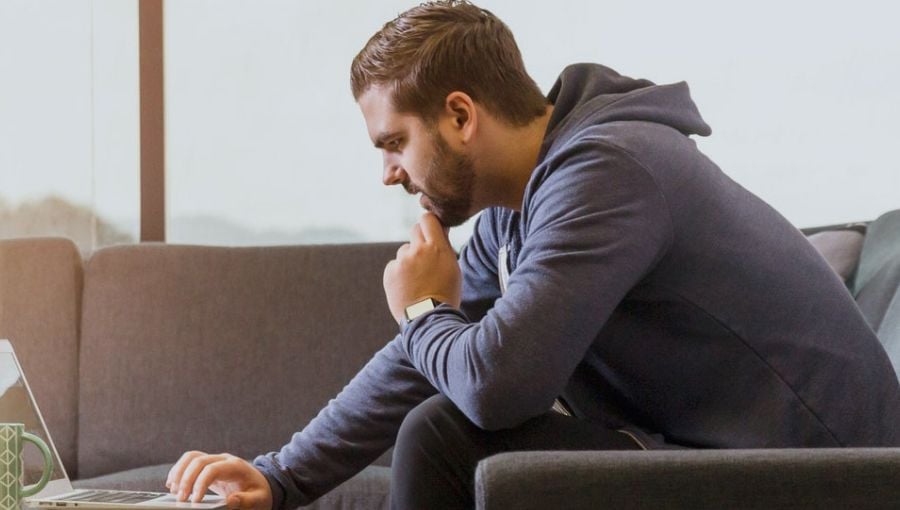 Marketing growth director controlling process of his team work on a laptop