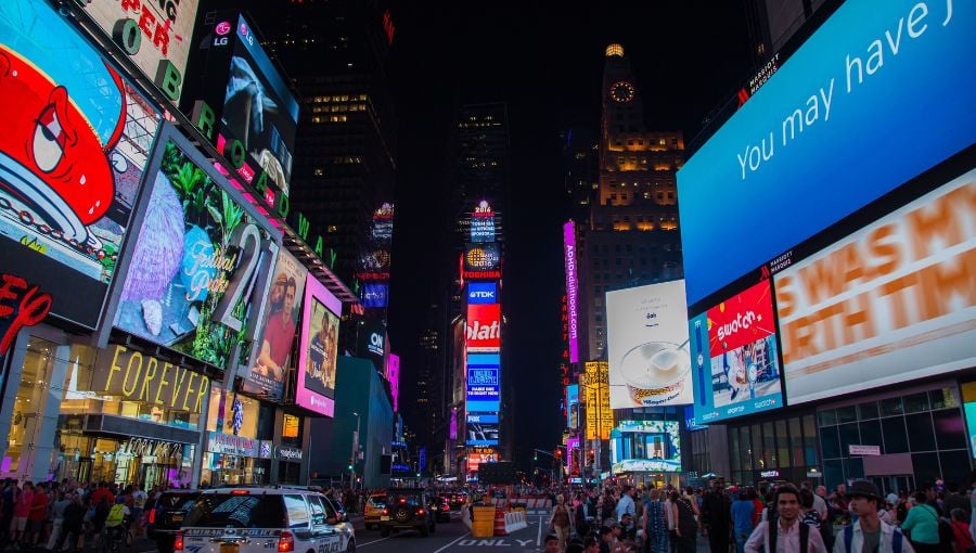 New York's Times Square at night crammed with cars and people