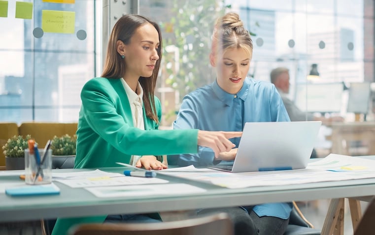 Project owners discussing design feedback by the office desk