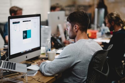Designer working on a marketing compliance process by his desk