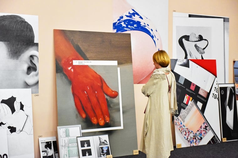 Collections of art in the museum being watched by a woman