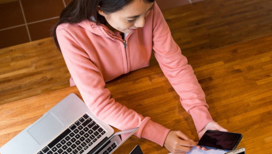 Woman reviewing Ziflow product releases of August 2019 by her laptop