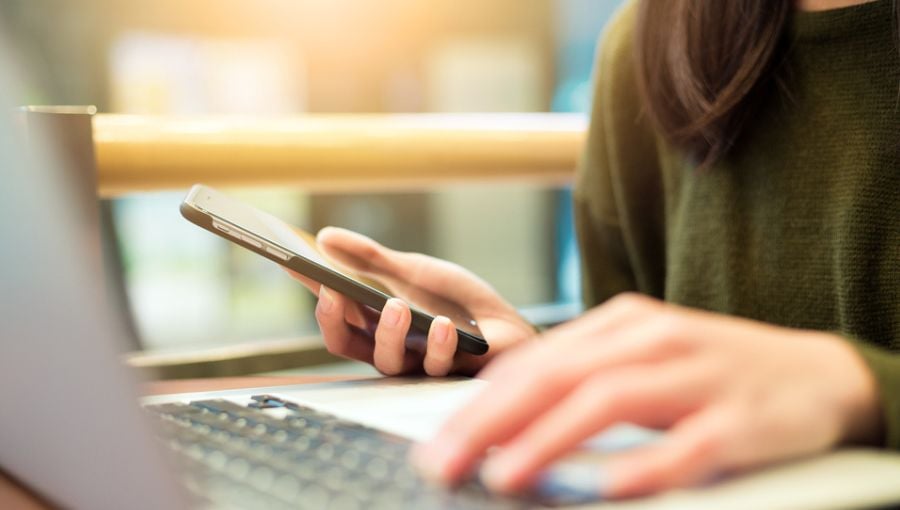 Woman working by her laptop on the newest Ziflow product update